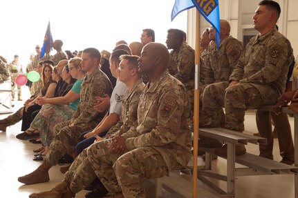attendees sit in bleachers at ceremony