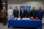 Honorees of Wall of Fame gather around cake