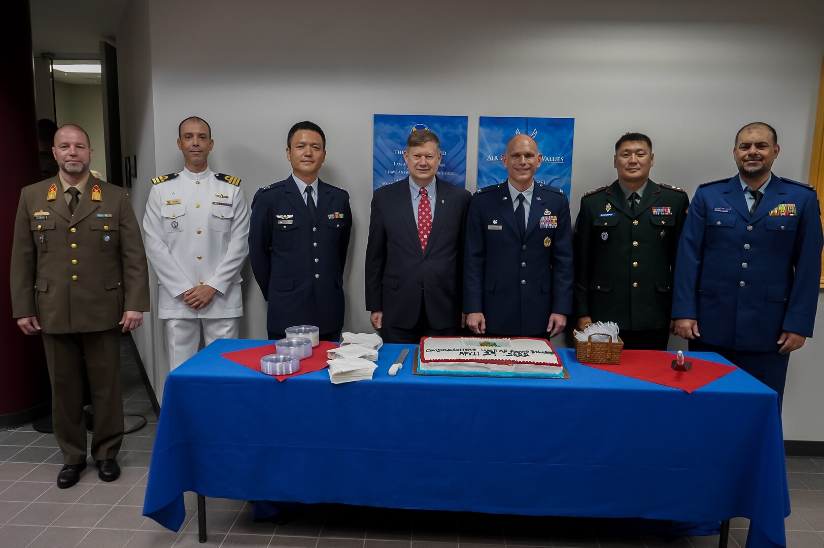 Honorees of Wall of Fame gather around cake