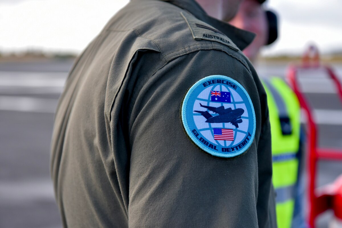 The official patch of Exercise Global Dexterity on the flight suit of Royal Australian Air Force Corporal Grant Vaughan, No. 36 Squadron loadmaster, at Joint Base Pearl Harbor-Hickam, Hawaii, May 3, 2022. The RAF squadron visited JBPHH to join both active duty and National Guard C-17s for training missions around the Hawaiian Islands to develop tactical airlift and airdrop capabilities. (U.S. Air Force photo by 1st Lt. Benjamin Aronson)