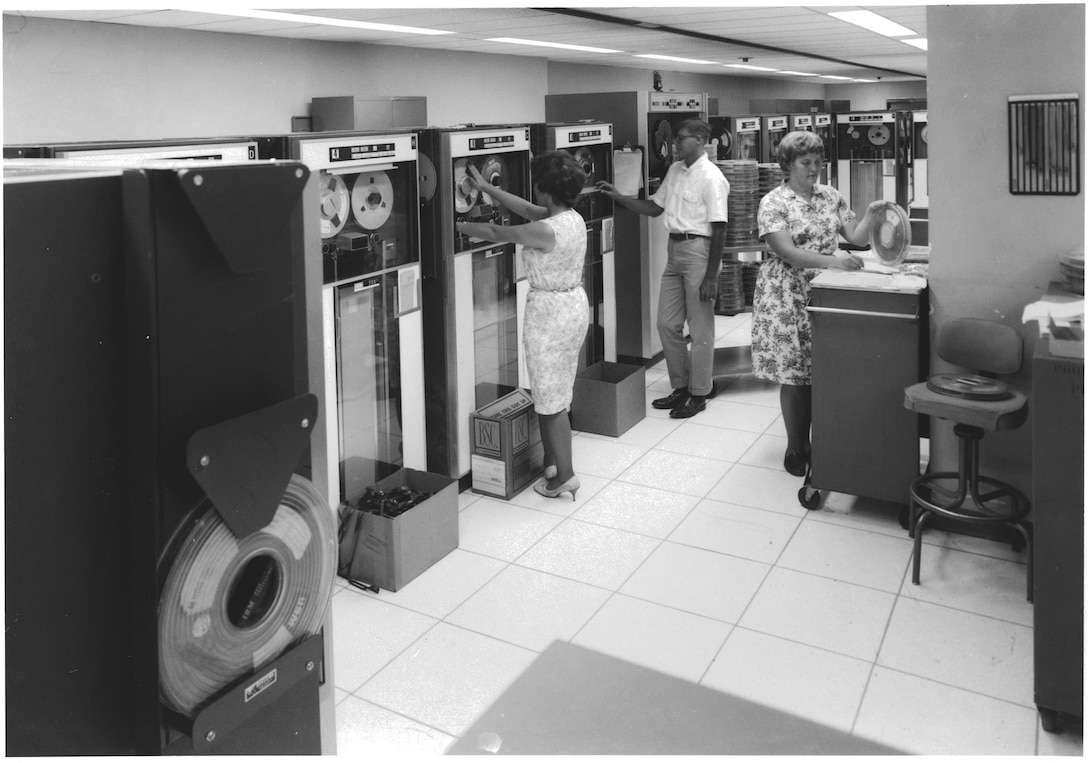 Defense Logistics Supply Agency personnel load magnetic reels on to data machines