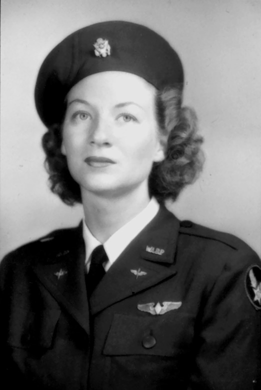 A woman wearing a uniform poses for an official photo, taken in black and white.