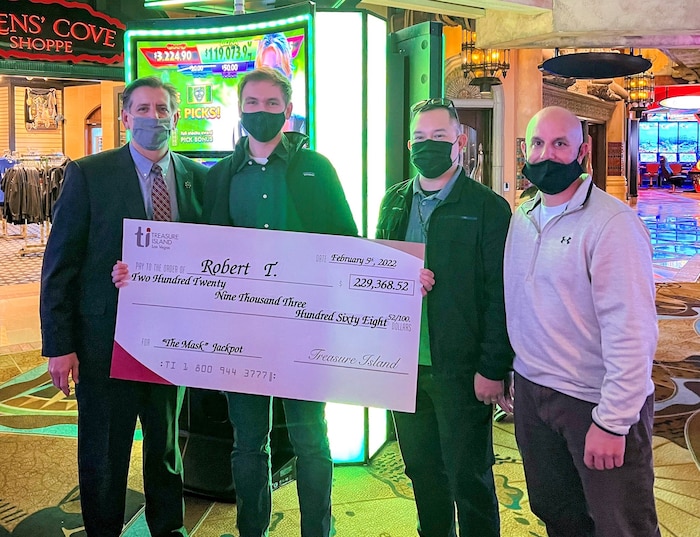 Air Force Reserve Maj. Dan Nuqui, right, went the extra mile to ensure Robert Taylor, second from left, received his jackpot. (Courtesy photo)
