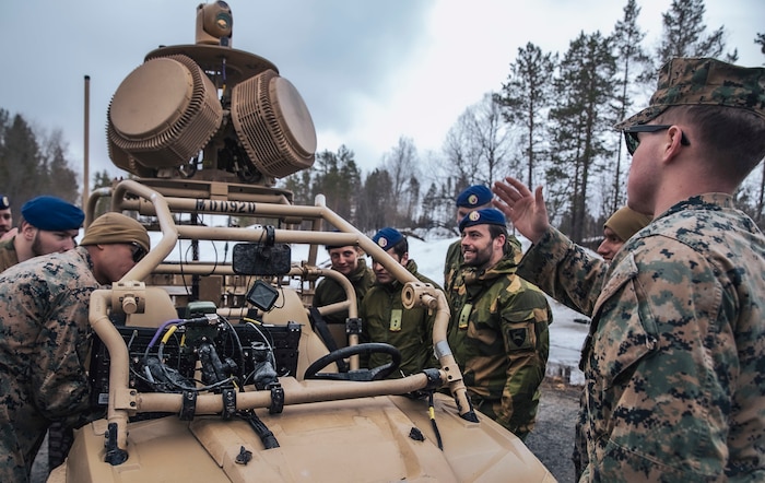 U.S. Marines assigned to the Aviation Combat Element, 22nd Marine Expeditionary Unit and members of the Norwegian Army discuss the capabilities of the Light-Marine Air Defense Integrated System during a bilateral training event in Setermoen, Norway, April 25, 2022.