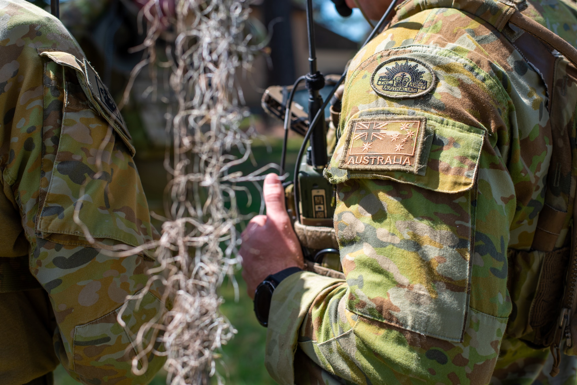 men stand shoulder to shoulder showing a uniform patch for Australia