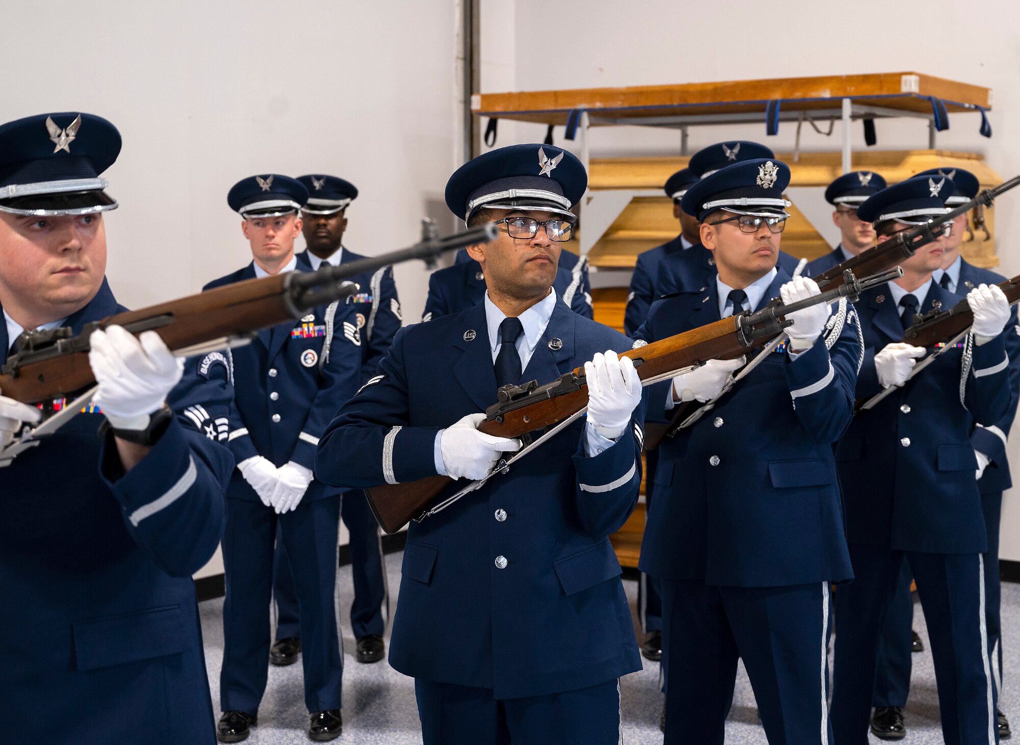 New members of the Wright-Patterson Air Force Base Honor Guard demonstrate the role a firing party plays in a military funeral during their graduation ceremony, April 25, 2022. Guardsmen demonstrated the full funeral service, including a six-man flag fold and taps, prior to receiving their honor guard badges. (U.S. Air Force photo by R.J. Oriez)