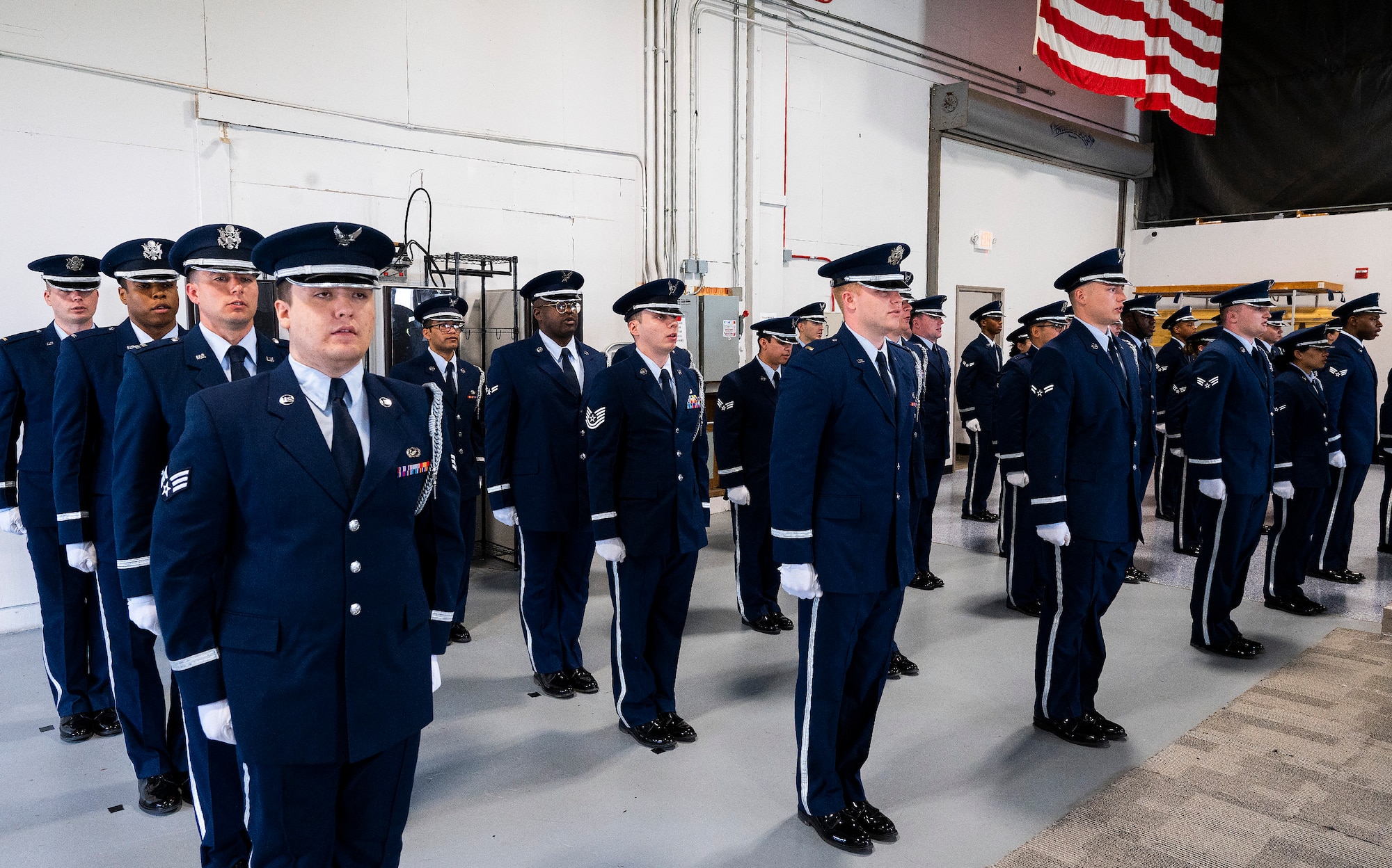 The class of new Wright-Patterson Air Force Base Honor Guard members recite the “Honor Guard Charge” at the end of their graduation ceremony, April 25, 2022. Thirty-nine Airmen from units across the base underwent more than 50 hours of training to become proficient in the customs and courtesies they will need during their six-month tour with the guard. (U.S. Air Force photo by R.J. Oriez)