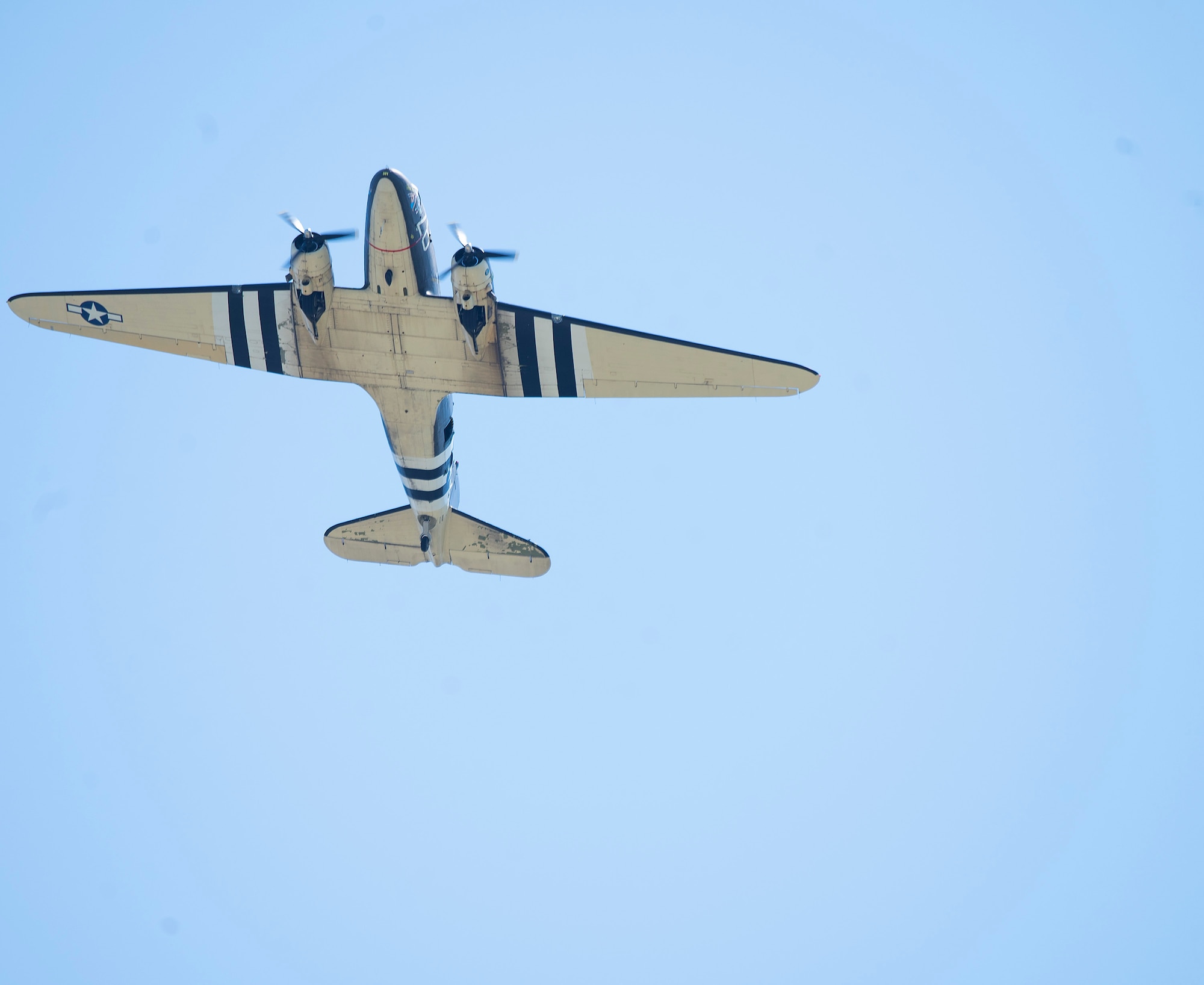 The C-47 Skytrain Tico Belle prepares to land on the runway behind the National Museum of the U.S. Air Force.