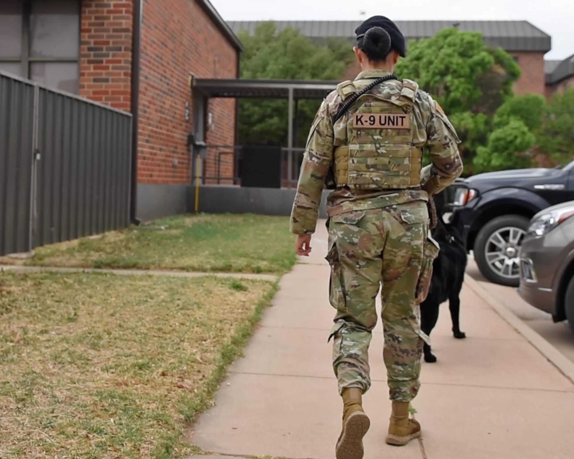 U.S. Air Force Senior Airman Georgina Silva, 17th Security Forces Squadron military working dog handler, and MWD Aghi, 17th Security Forces Squadron detection dog, patrol Goodfellow Air Force Base, Texas, April 22, 2022. Silva and Aghi performed unscheduled inspections during their shift to ensure the safety of Goodfellow AFB. (U.S. Air Force photo by Airman 1st Class Sarah Williams)