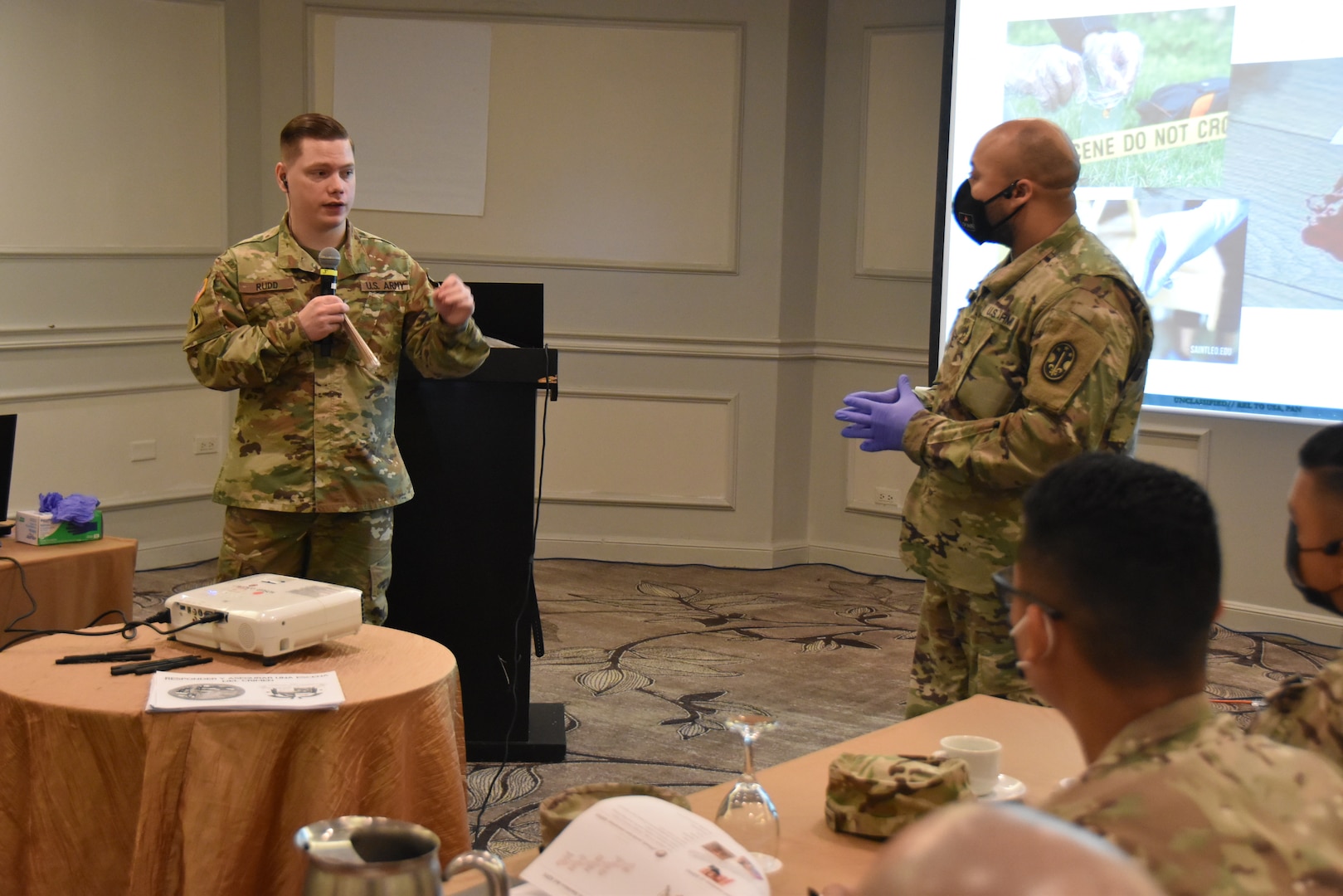 Staff Sgt. William Rudd, 1175th Military Police Co., facilitates a presentation on taking DNA evidence with Staff Sgt. Jaymes Dooley (1139th MP Co.), serving as a demonstrator. The presentation was part of a crime scene investigation subject matter expert exchange between Missouri National Guard Soldiers and members of Panama's law enforcement and protection agencies. The Missouri National Guard has partnered with the country of Panama since 1996 under the Department of Defense National Guard Bureau State Partnership Program.