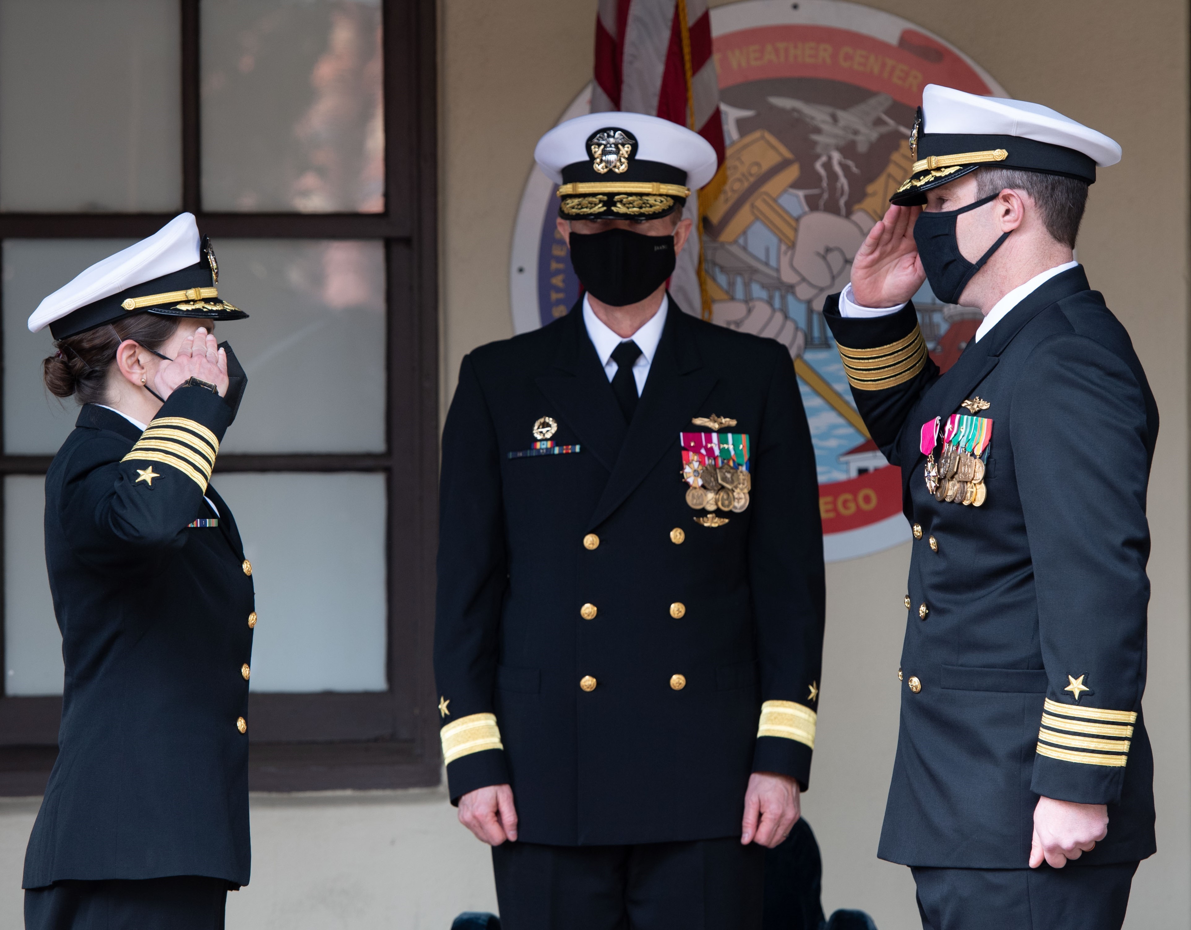 Standing before Rear Admiral Ronald J. Piret, Commander, Naval Meteorology Oceanography Command, Captain Kate Hermsdorfer relieves Captain Shane Stoughton, as Commanding Officer of Fleet Weather Center San Diego during a Change of Command Ceremony at Naval Air Station North Island