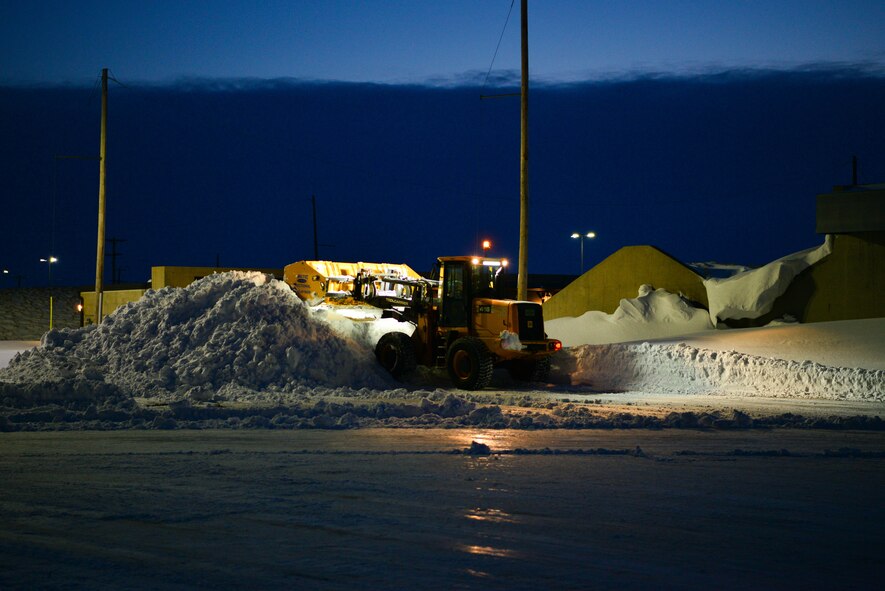 A snow plow plows the flight line at Minot Air Force Base, North Dakota