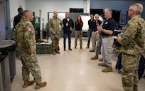Casey Collins, second from the right, the deputy to the commander assigned to Joint Task Force Civil Support, discusses how JTF-CS would deploy and respond to a catastrophic natural or manmade incident with Commander, Contingency Command Post 1, Task Force 51, US Army North, Maj. Gen. William Prendergast, center left, who is acting as the deputy exercise director during Exercise Vibrant Response 22, April 25, 2022.