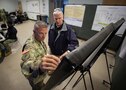 Maj. Gen. Jeff Van, left, Joint Task Force Civil Support commanding general, and Casey Collins, the deputy to the commander assigned to JTF-CS, discuss potential response options to a simulated manmade catastrophic incident during Exercise Vibrant Response 22, April 25, 2022.