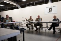 Joint Task Force Civil Support Commanding General, Maj. Gen. Jeff Van, center, and U.S. Army North Commanding General, Lt. Gen. John Evans, center right, discuss the roles, responsibilities and capabilities of a defense coordinating element at FEMA Region 8 headquarters in Denver during Exercise Vibrant Response 22, April 26, 2022.