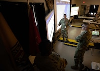 Joint Task Force Civil Support commanding general, Maj. Gen. Jeff Van, center, discusses mission tracking and forces flowing into the operations area during a simulated chemical, biological, radiological and nuclear incident response as part of Exercise Vibrant Response 22, April 27, 2022.