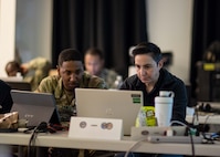Deserie Soliz, right, assigned to the Joint Task Force Civil Support chemical, biological, radiological and nuclear planning cell, and U.S. Army Sgt. 1st Class Jarayle Williams, assigned to the 157th Infantry Brigade, and acting as an observer/controller trainer during Exercise Vibrant Response 22, review a simulated nuclear detonation plume model as part of the exercise, April 27, 2022.