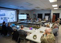 Casey Collins, center rear, Joint Task Force Civil Support deputy to the commanding general, gives a JTF-CS 101 brief to a group of distinguished visitors including U.S. Army Lt. Gen. A.C. Roper, the U.S. Northern Command Deputy Commander, and Nancy Dragani, the Federal Emergency Management Agency Region 8 Regional Administrator, during Vibrant Response 22, April 29, 2022.