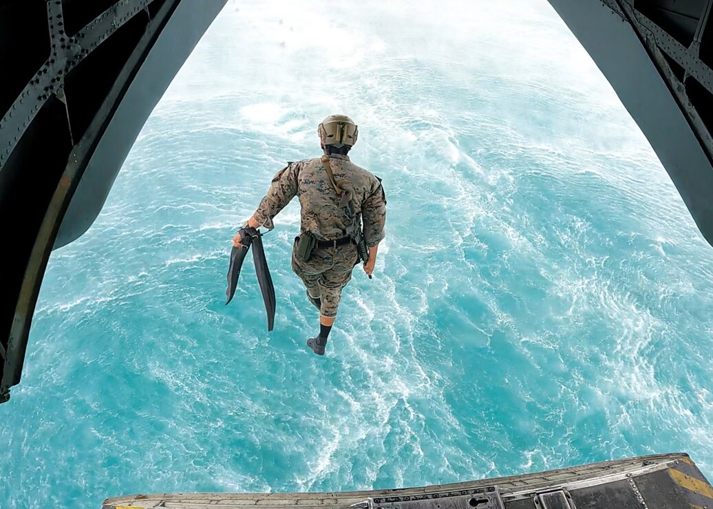 A U.S. Marine with Battalion Landing Team 1/5, 31st Marine Expeditionary Unit, jumps from a CH-53E Super Stallion during a helocast at Kin Blue, Okinawa, Japan, Apr. 27, 2022. The 31st MEU, the Marine Corps' only continuously forward-deployed MEU, provides a flexible and lethal force ready to perform a wide range of military operations as the premier crisis response force in the Indo-Pacific region.
