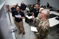Hans Lageschulte, an exercise program manager with Joint Task Force Civil Support, holds a meeting with JTF-CS and L2 Defense members as part of exercise Guardian Response (GR) 22 at Camp Atterbury, Ind., May 4. as part of exercise Guardian Response (GR) 22 at Camp Atterbury, Indiana, May 4. GR22 is a U.S. Army Forces Command-directed external evaluation and culminating training event for U.S. Northern Command’s Chemical, Biological, Radiological and Nuclear Response Enterprise consequence management entities. The exercise is focused on the Defense Support of Civil Authorities mission sets.