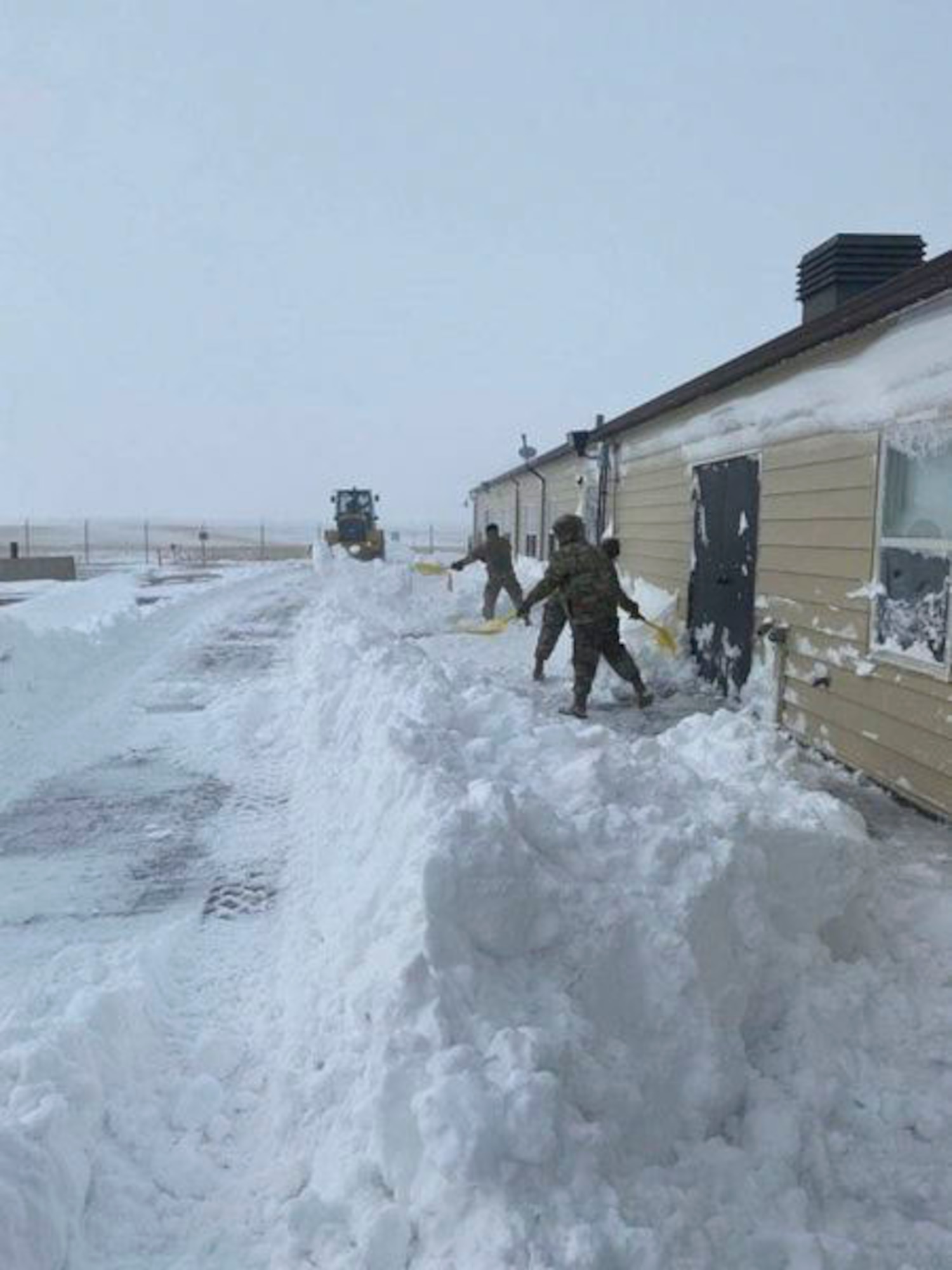 Team Minot Airmen shovel snow on an off base installation April 14, 2022 on Minot Air Force Base, North Dakota.