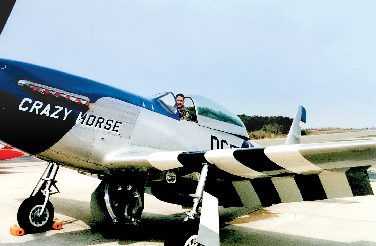 Chebi poses for a photo in the cockpit of a P-51 Mustang circa 1995 at the United States Naval Test Pilot School at Naval Air Station Patuxent River, Md.