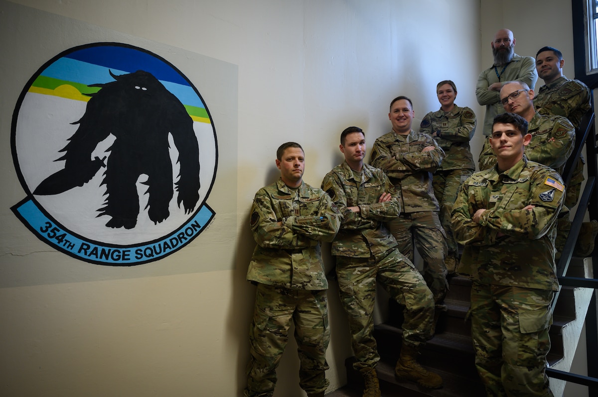 U.S. Airmen, Guardian and civilian personnel assigned to the 354th Range Squadron pose for a group photo on Eielson Air Force Base, Alaska, May 5, 2022.