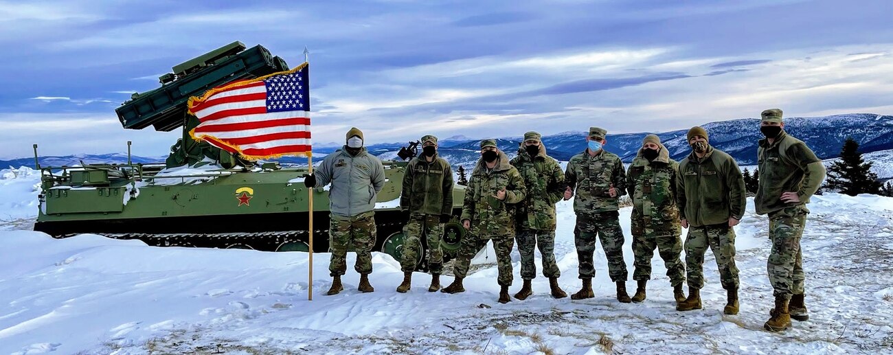 U.S. Airmen assigned to the 354th Range Squadron pose for a group photo at the Joint Pacific Alaska Range Complex.