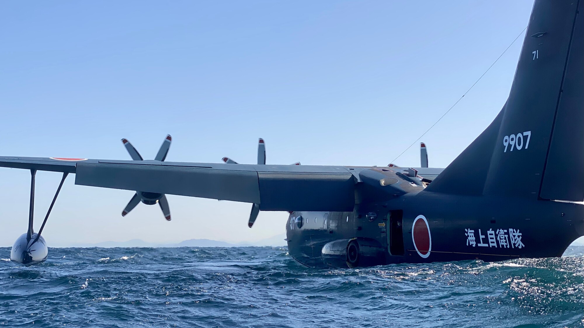 A ShinMaywa US-2 assigned to the Japanese Maritime Self-Defense Force's Air Patrol Squadron 71 idles in the sea while the crew completes rescue swimmer drills off the coast of Marines Corps Air Station Iwakuni, Japan, April 5, 2022. U.S. Special Operations and Japanese Self Defense Forces’ ability to work together, utilizing abilities like the US-2’s amphibious airpower, is essential to being able to provide rescue and humanitarian response in a region covered by water and outlying islands. (U.S. Air Force photo by Capt. Joshua Thompson)