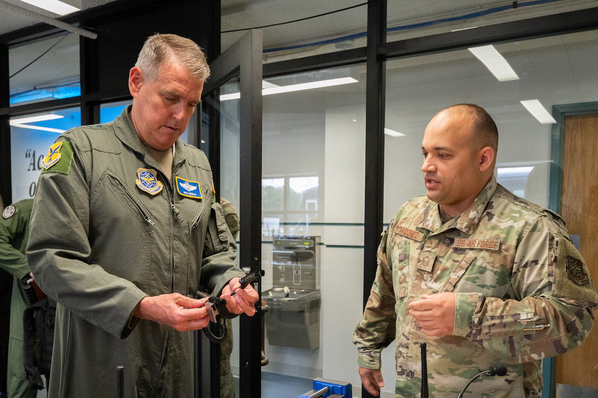 From the right, MSgt. Brandon Vasquez, 436th Airlift Wing Bedrock Innovation Lab chief technology officer shows Gen. Mike Minihan, Air Mobility Command commander, innovative tools that were conceptualized by Team Dover Airmen at Dover Air Force Base, Delaware, May 5, 2022. Airmen at Bedrock’s facilities are empowered to collaborate and innovate new technologies to improve everyday tasks vital to their mission. (U.S. Air Force photo by Mauricio Campino)