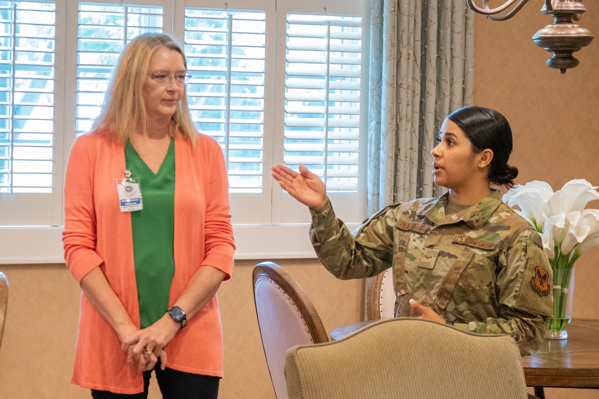From the right, Airman 1st Class Angie Pena Felix, Air Force Mortuary Affairs Operations Fisher House manager, gives a tour of the Fisher House to Ashley Minihan, wife of Gen. Mike Minihan, Air Mobility Command commander, on Dover Air Force Base, Delaware, May 5, 2022. Spouses of AMC leadership toured several base facilities during a visit to Dover AFB. (U.S. Air Force photo by Mauricio Campino)