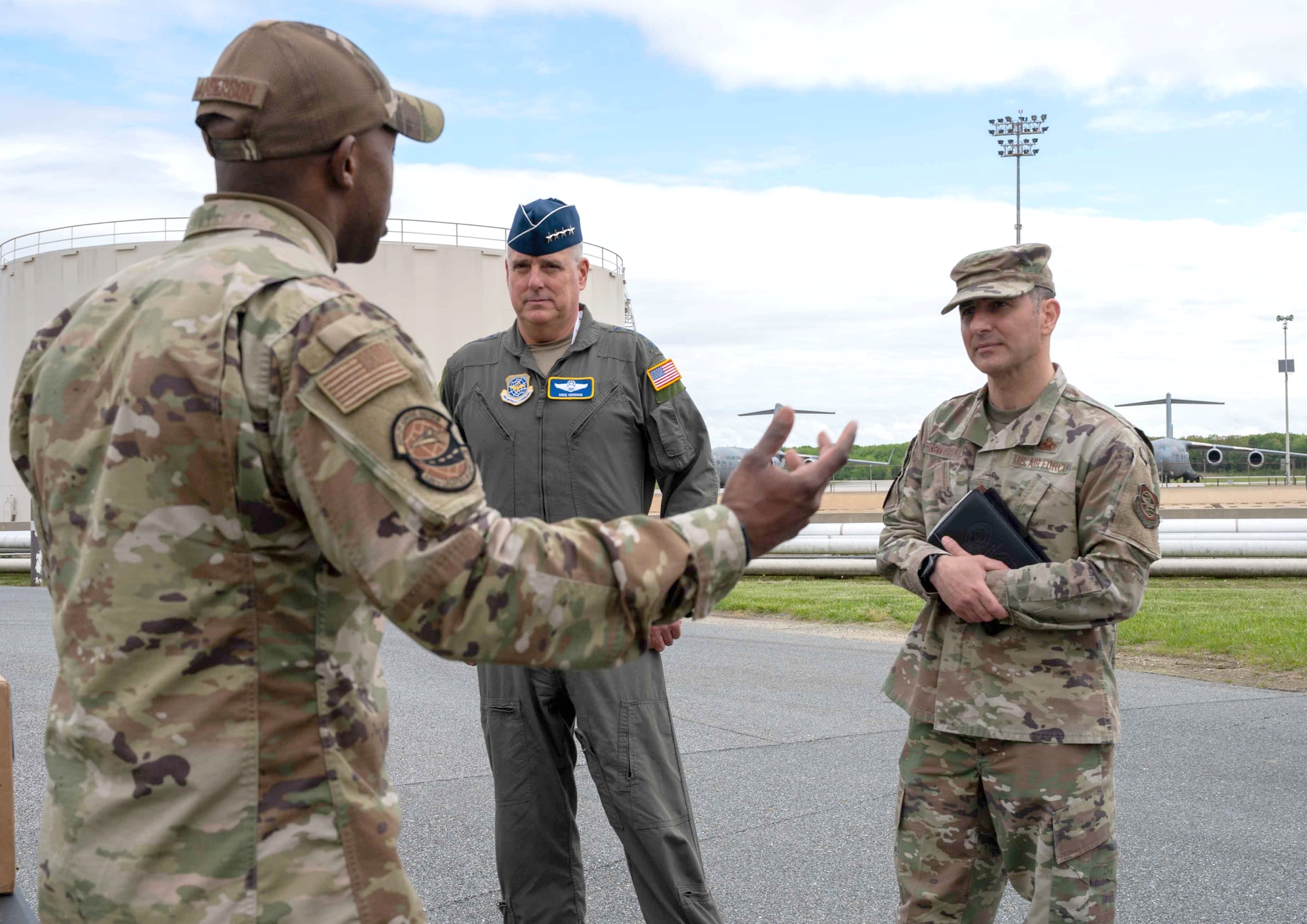 Tech. Sgt. Jamaul Anderson, 436th Logistics Readiness Squadron warehouse operations noncommissioned officer in charge, briefs Gen. Mike Minihan, center, Air Mobility Command commander, and Chief Master Sgt. Brian Kruzelnick, right, AMC command chief, at Dover Air Force Base, Delaware, May 5, 2022. During their visit, AMC leadership highlighted top performing Airmen and toured base facilities such as the C-5 isochronal dock, the air traffic control tower and the Tactics and Leadership Nexus. (U.S. Air Force photo by Senior Airman Faith Schaefer)