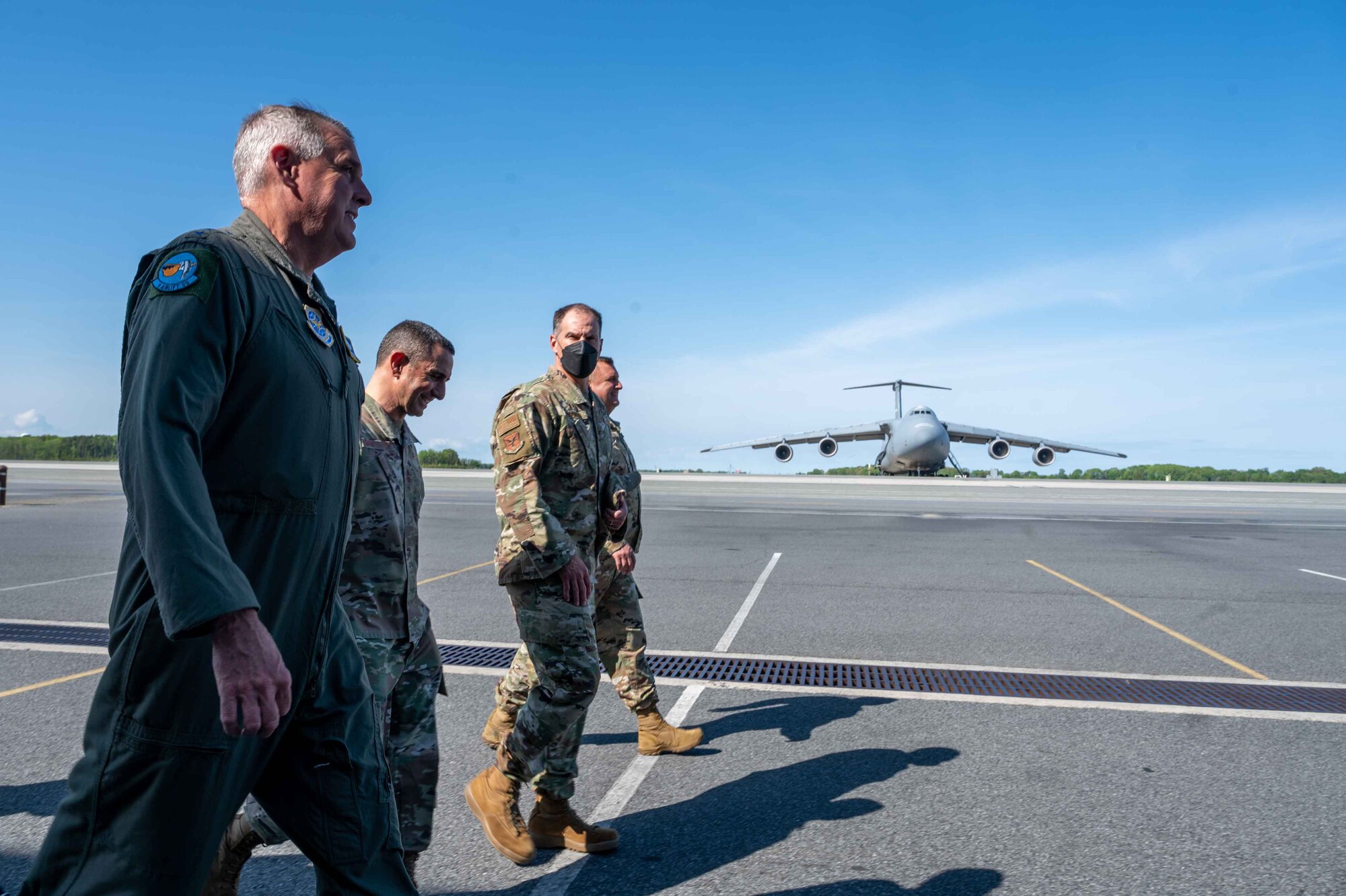 From the left, Gen. Mike Minihan, Air Mobility Command commander, and Chief Master Sgt. Brian Kruzelnick, AMC command chief, walk along the flight line at Dover Air Force Base, Delaware, with Col. Matt Husemann, 436th Airlift Wing commander, May 5, 2022. During their visit, AMC leadership highlighted top performing Airmen and toured base facilities such as the C-5 isochronal dock, the air traffic control tower and the Tactics and Leadership Nexus. (U.S. Air Force photo by Senior Airman Faith Schaefer)