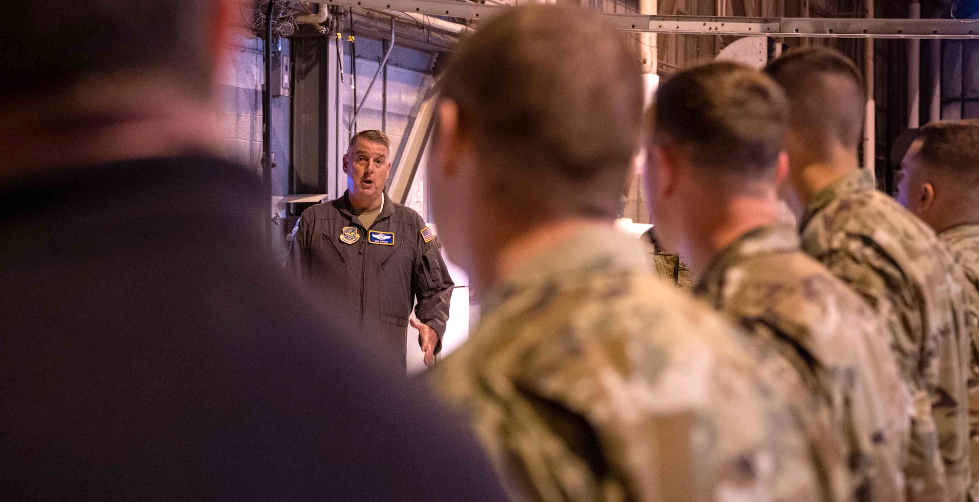 Gen. Mike Minihan, Air Mobility Command commander, speaks to Airmen at the C-5 Isochronal Dock at Dover Air Force Base, Delaware, May 5, 2022. During his visit, Minihan was briefed on Iso-dock operations and a new innovative workflow to expedite aircraft maintenance. (U.S. Air Force photo by Senior Airman Faith Schaefer)