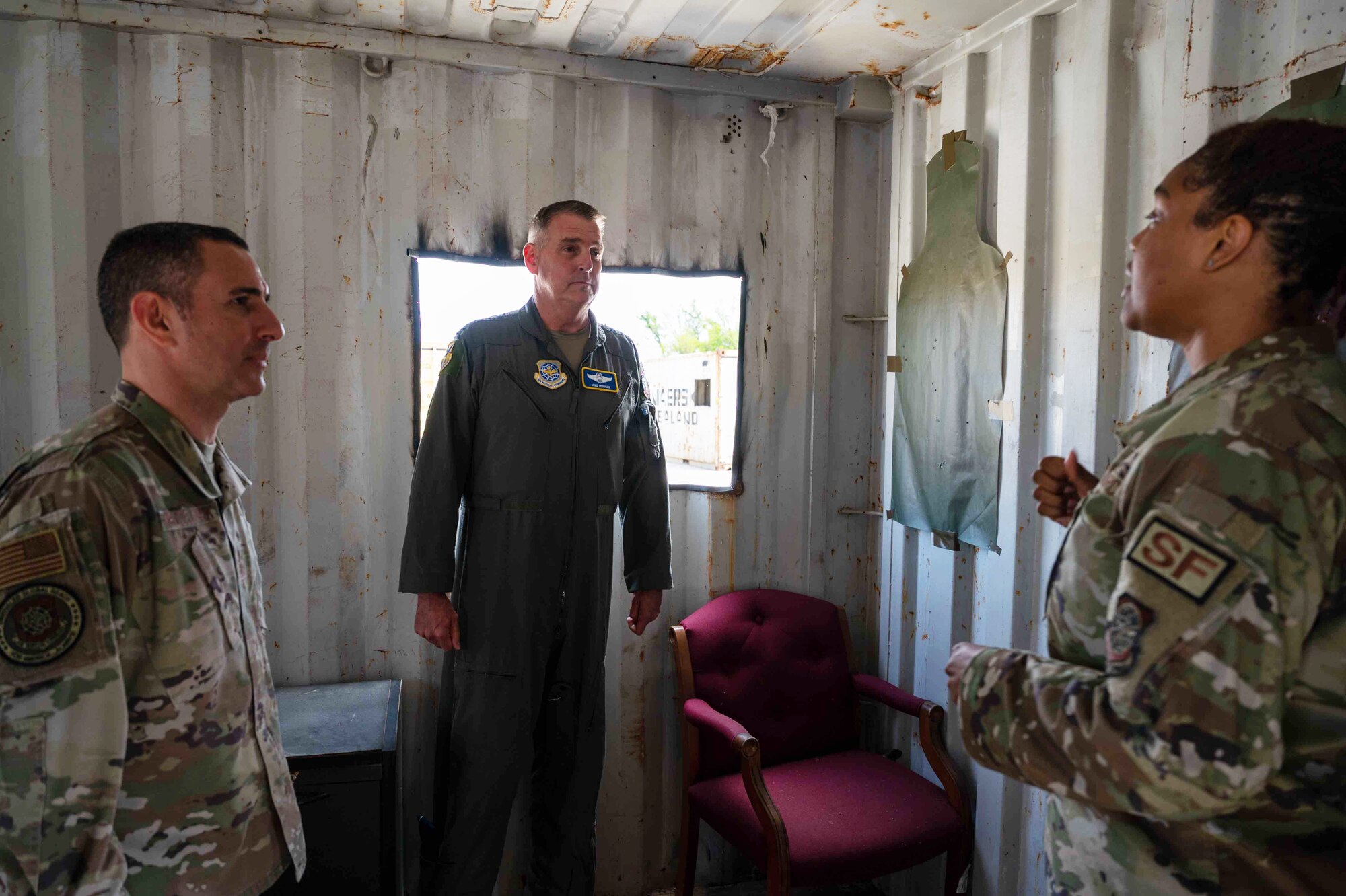 Tech. Sgt. Monique Young, right, 436th Airlift Wing Tactics and Leadership Nexus noncommissioned officer in charge, briefs Gen. Mike Minihan, Air Mobility Command commander, and Chief Master Sgt. Brian Kruzelnick, AMC command chief, on the functions and benefits of the TALN complex at Dover Air Force Base, Delaware, May 5, 2022. The TALN complex is a first-of-its-kind permanent integrated combat and leadership training facility on base. (U.S. Air Force photo by Senior Airman Faith Schaefer)