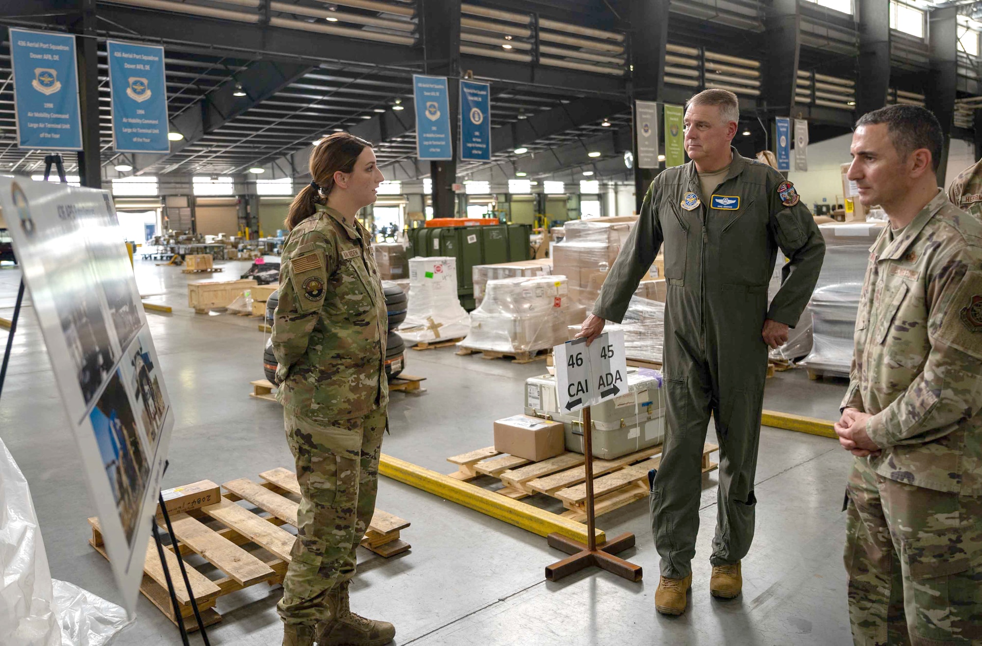 Senior Airman Kaitlyn Van Orden, 436th Aerial Port Squadron ramp specialist, briefs Gen. Mike Minihan, middle, Air Mobility Command commander, and Chief Master Sgt. Brian Kruzelnick, left, AMC command chief, on Foreign Military Sales missions at Dover Air Force Base, Delaware, May 5, 2022. The 436th APS “Super Port” processes $3.5 billion of FMS cargo annually. (U.S. Air Force photo by Senior Airman Faith Schaefer)