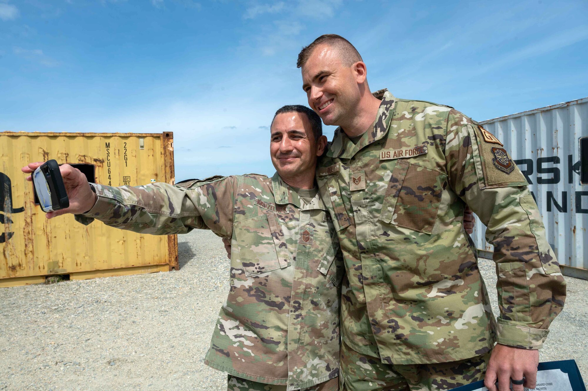 Chief Master Sgt. Brian Kruzelnick, Air Mobility Command command chief, takes a selfie with Staff Sgt. Paul Dell, 436th Airlift Wing Tactics and Leadership Nexus specialist, at Dover Air Force Base, Delaware, May 5, 2022. The TALN complex is a first-of-its-kind permanent integrated combat and leadership training facility. (U.S. Air Force photo by Senior Airman Faith Schaefer)