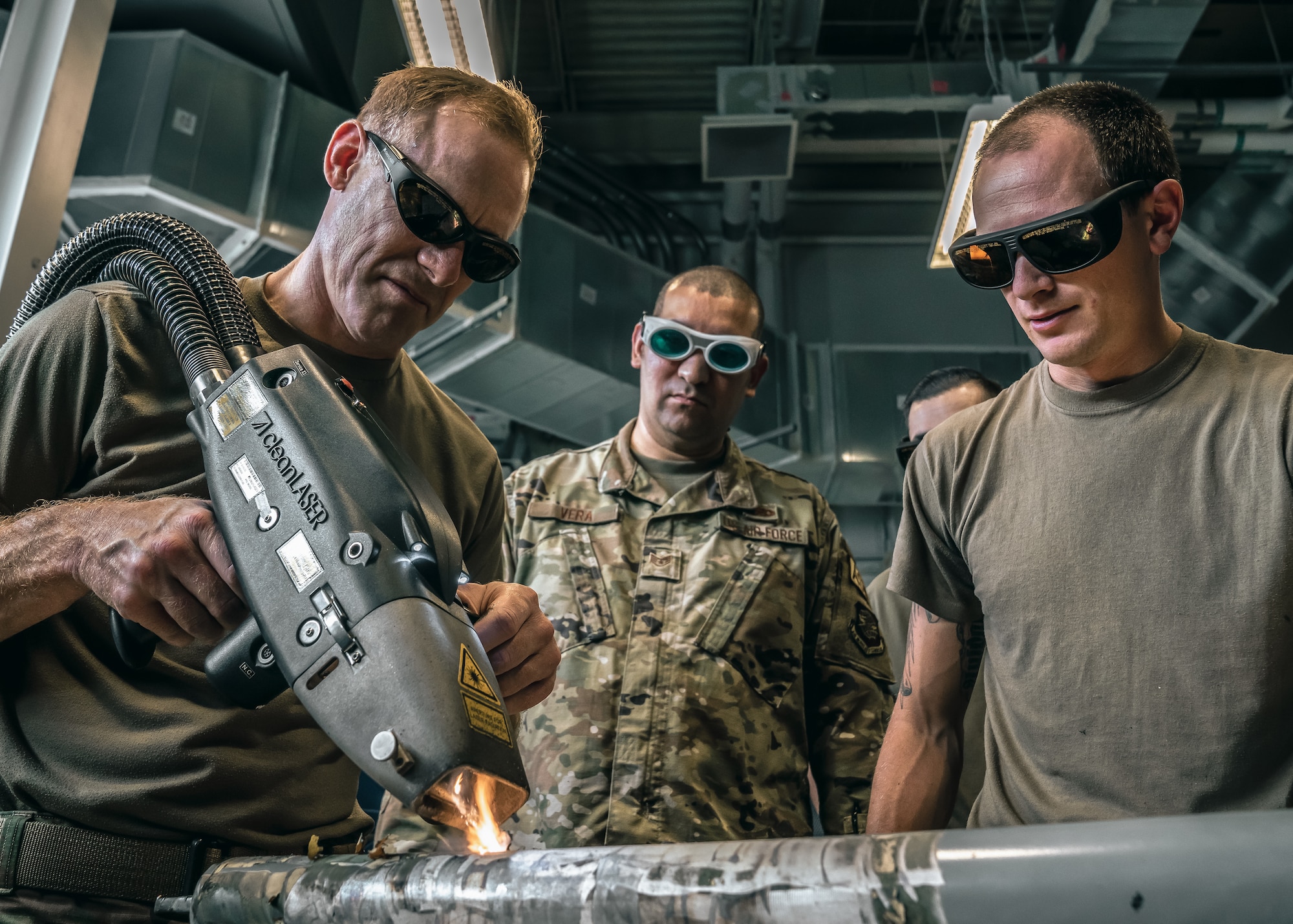 U.S. Air Force Col. Benjamin Jonsson, left, 6th Air Refueling Wing commander, learns how to use a CL2000 laser as a part of a visit with the 6th Maintenance Squadron corrosion control unit at MacDill Air Force Base, Florida, April 28, 2022.