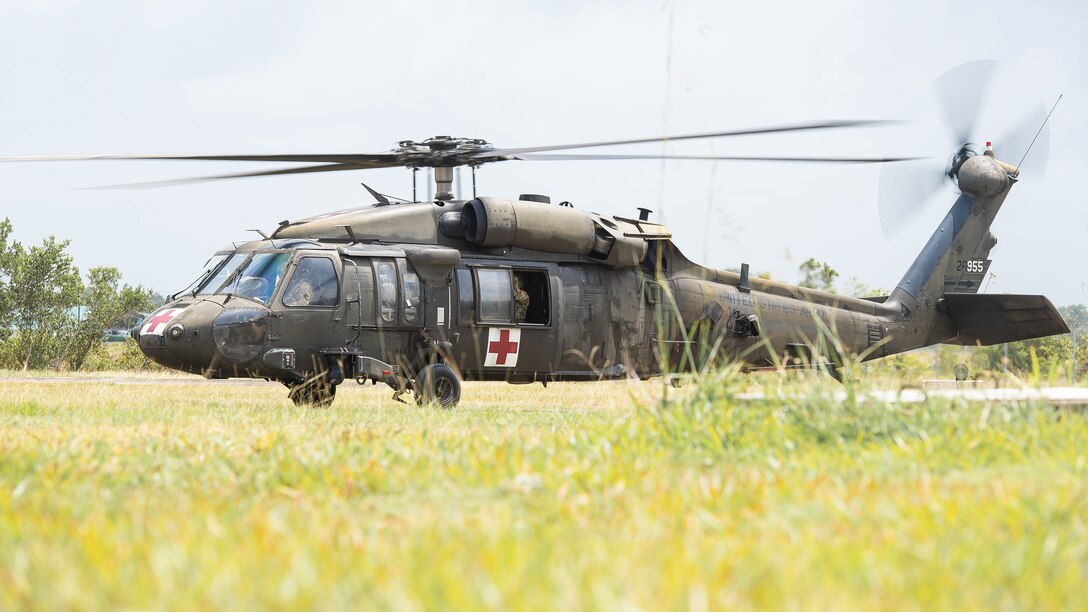 A military helicopter prepares for takeoff.