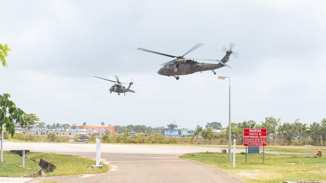 Military helicopters take off.