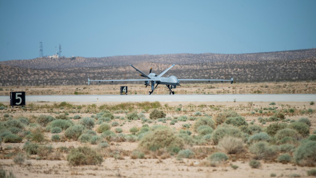 An MQ-9 Reaper from the 163rd Attack Wing, lands on Edwards Air Force Base, California, May 4. The aircraft conducted an Agile Combat Employment (ACE) to a Forward Operating Site (FOS), flying from March Air Reserve Base to Edwards Air Force Base. (Air Force photo by Madeline Guadarrama)