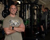Fitness trainer poses for a photo inside the Duke Dome