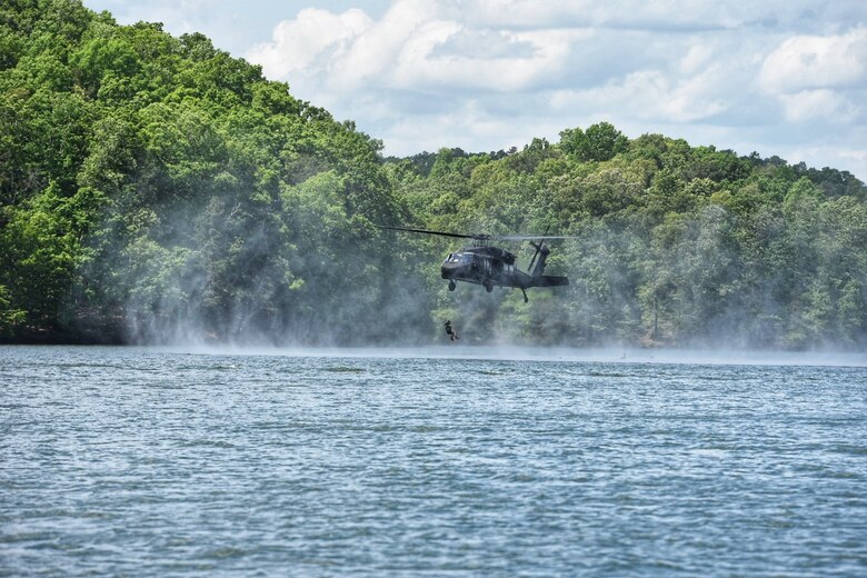 A Soldier from the 5th Ranger Training Battalion jumps from a UH-60 Black Hawk helicopter into Lake Lanier, Georgia, May 3, 2022. Helocasting is an insertion technique developed by Airborne troops whereby Soldiers step off the aircraft's ramp at a low altitude and low speed directly into the water below. (U.S. Army photo by Christopher Carranza)