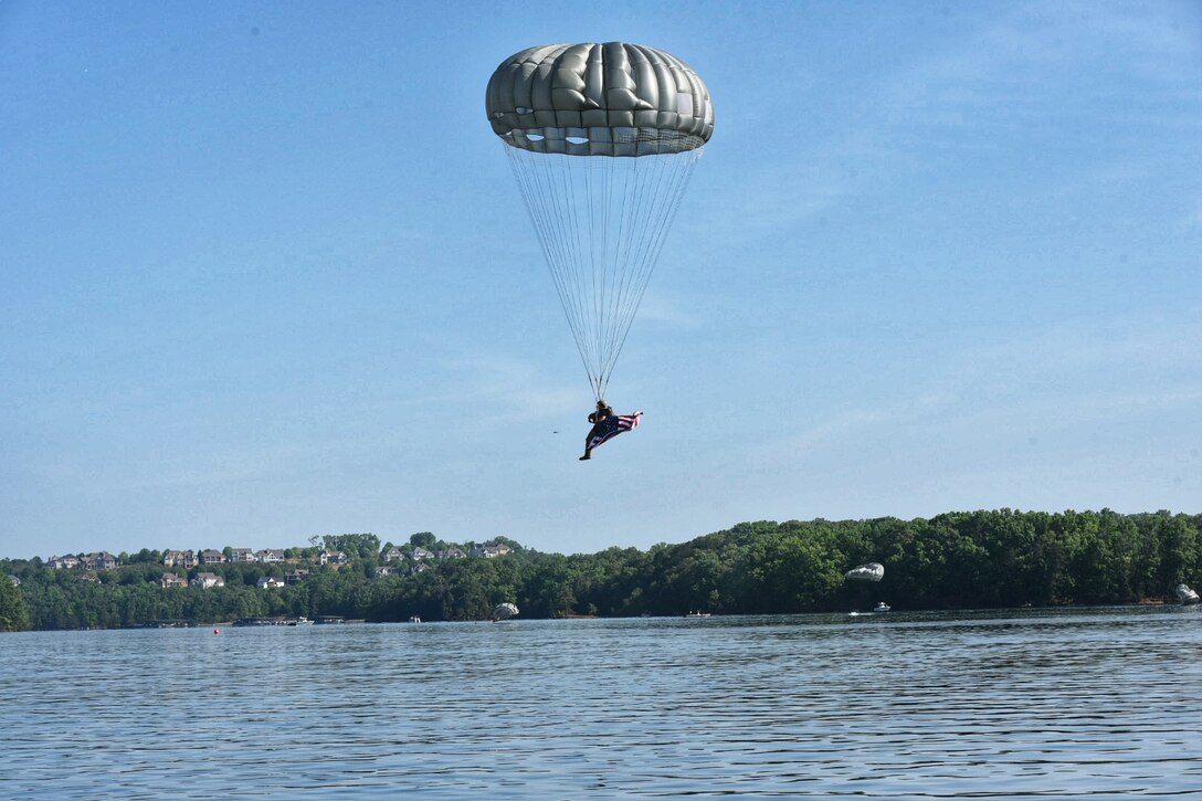 A Soldier from the 5th Ranger Training Battalion parachutes into Lake Lanier, Georgia, May 5, 2022. This training involves jumpers practicing with a parachute coming down over their head in the water, surfacing and swimming out. (U.S. Army photo by Christopher Carranza)