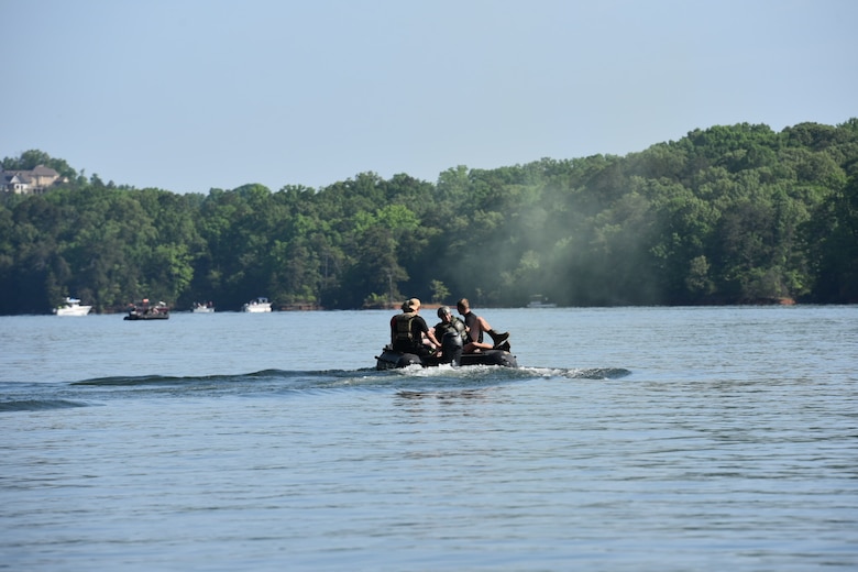 Soldiers from the 5th Ranger Training Battalion recover a parachutist into their Zodiac (combat rubber raiding craft) May 5, 2022, at Lake Sidney Lanier, Georgia. Soldiers jumped from UH-60 Black Hawks into Lake Lanier for their annual water proficiency training. (U.S. Army photo by Christopher Carranza)