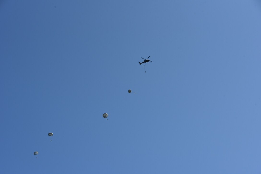 Soldiers from the 5th Ranger Training Battalion jump from a UH-60 Black Hawk Helicopter into Lake Lanier, Georgia, May 5, 2022. This training involves jumpers practicing with a parachute coming down over their head in the water, surfacing and swimming out. (U.S. Army photo by Christopher Carranza)