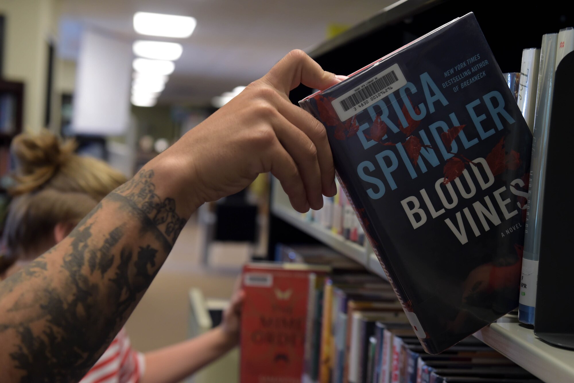 A photo of Airman picking book.