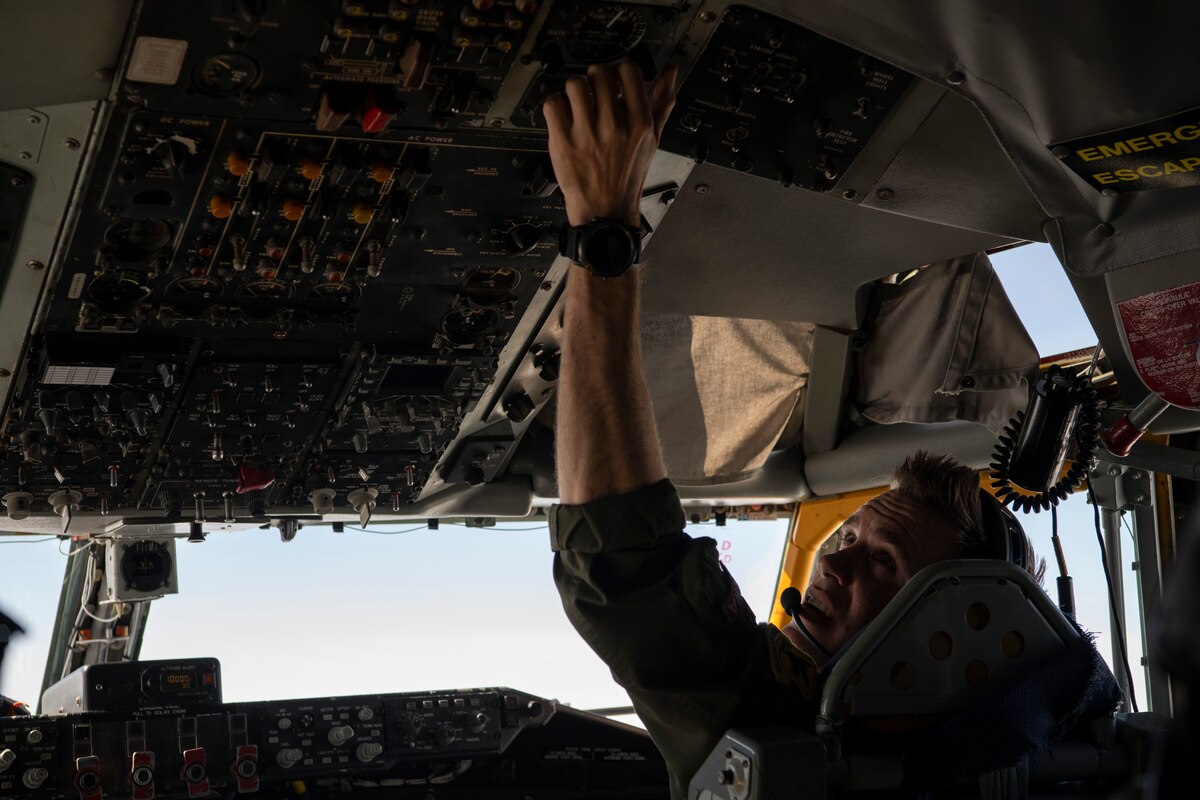 A photo of a fighter aircraft refueling while flying