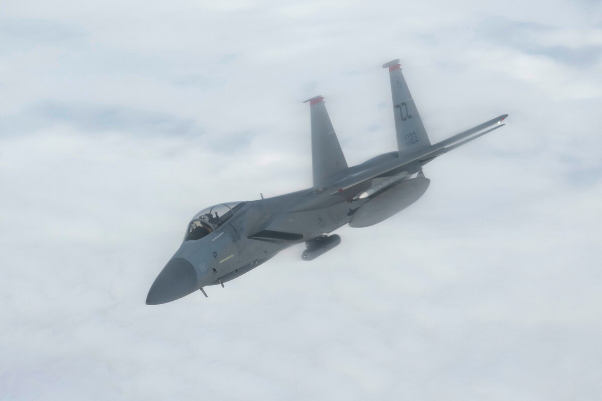 A photo of a fighter aircraft refueling while flying