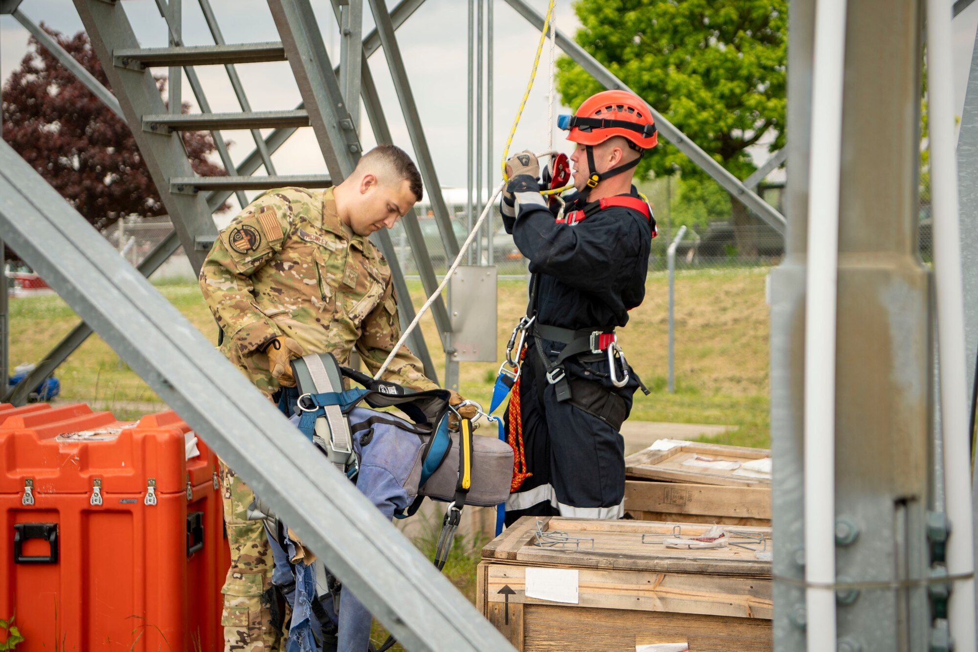 Staff Sgt. Sean Howley, left, 52nd Civil Engineer Squadron non-commissioned officer in charge of fire prevention, and Airman 1st Class Isaac Painter, 52nd CES firefighter, rescue a rescue dummy, May 4, 2022, on Spangdahlem Air Base, Germany. The 52nd Fighter Wing Safety office hosted a Fall Rescue demonstration at the radar tower with the 52nd CES fire department. (U.S. Air Force photo by Airman 1st Class Jessica Sanchez-Chen)